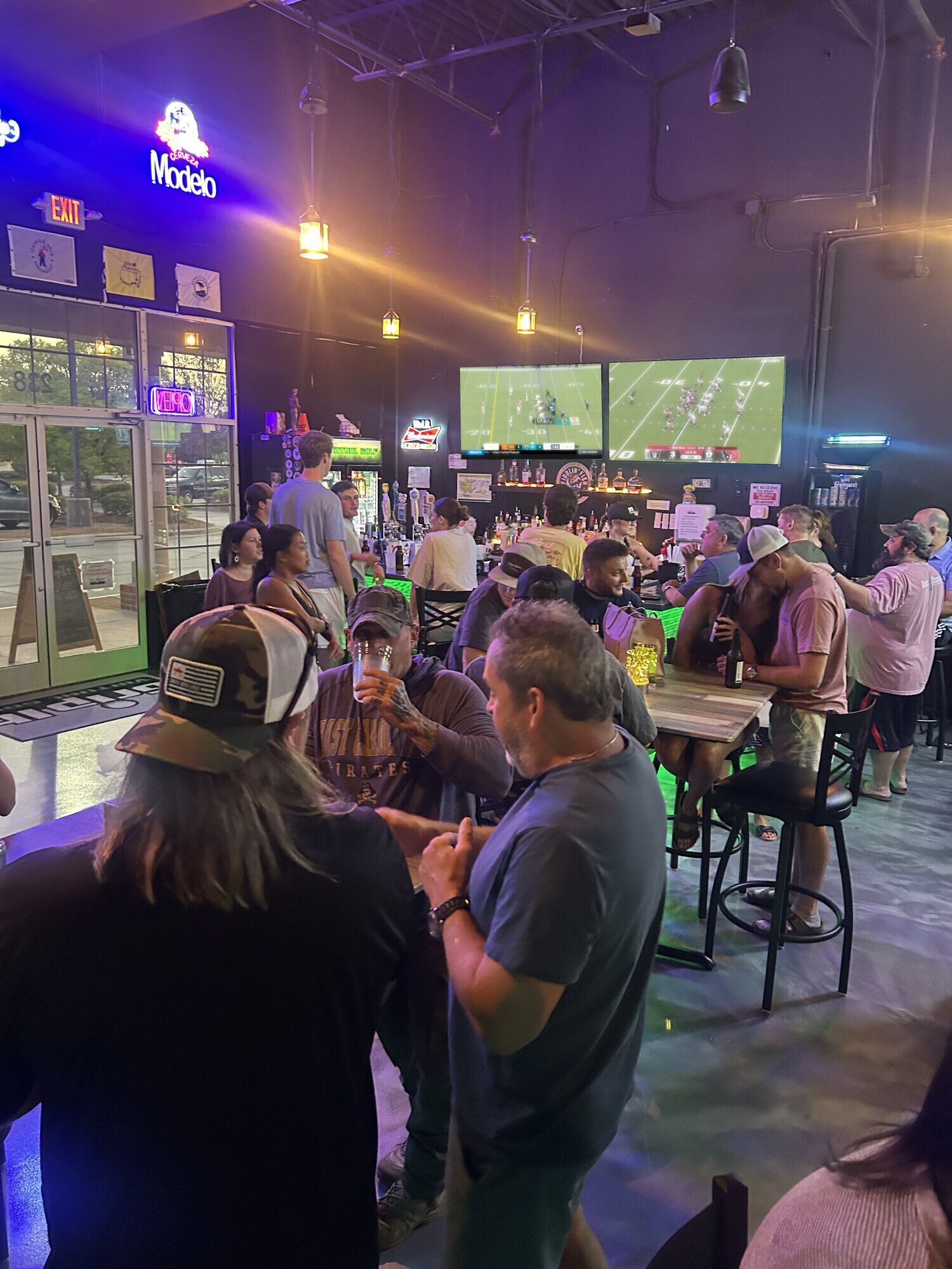 Sunday football crowd at the Grip It bar with the games on both TVs